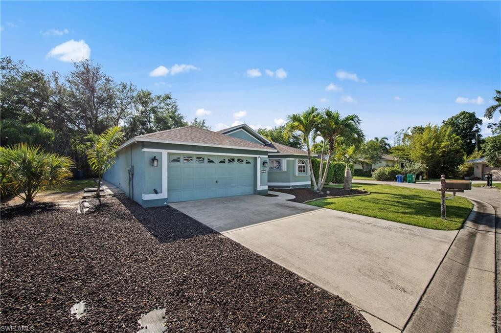 Single-story residence featuring a two-car garage, a concrete driveway, and a shingle roof
