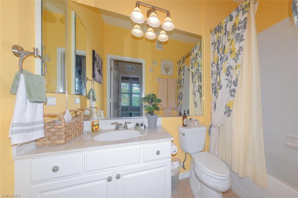 Guest Bathroom with full tub and shower, Tiled floor and upgraded lighting.