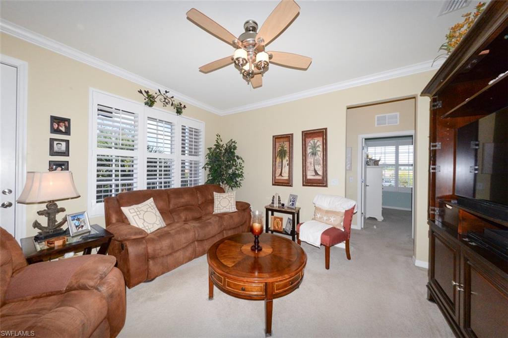 Spacious Great Room features 9'4" ceilings, Crown Molding, Plantation shutters, French door to Lanai and open to the Breakfast bar and Kitchen.