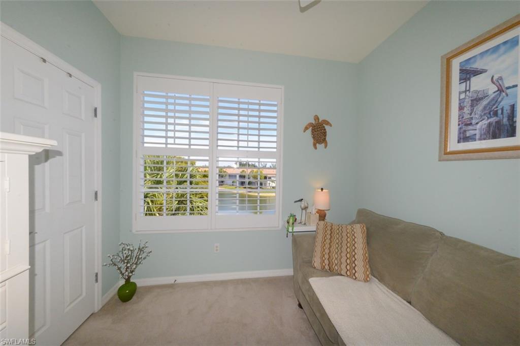 Guest bedroom with  Plantation shutters, closet and view of Lake. Currently used as den with sleeper sofa.