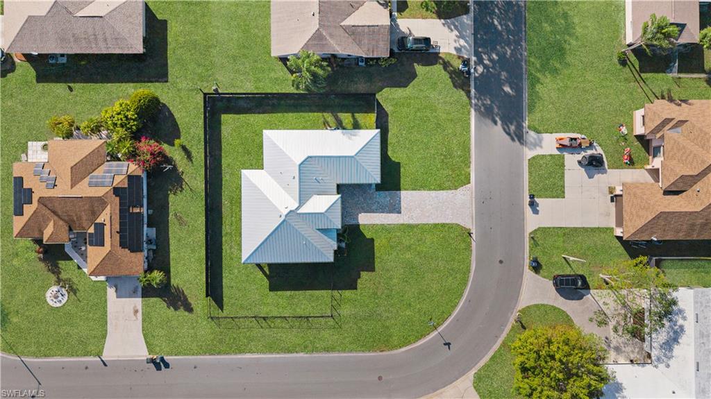 Single-story residence featuring a metal roof and an L-shaped architectural design