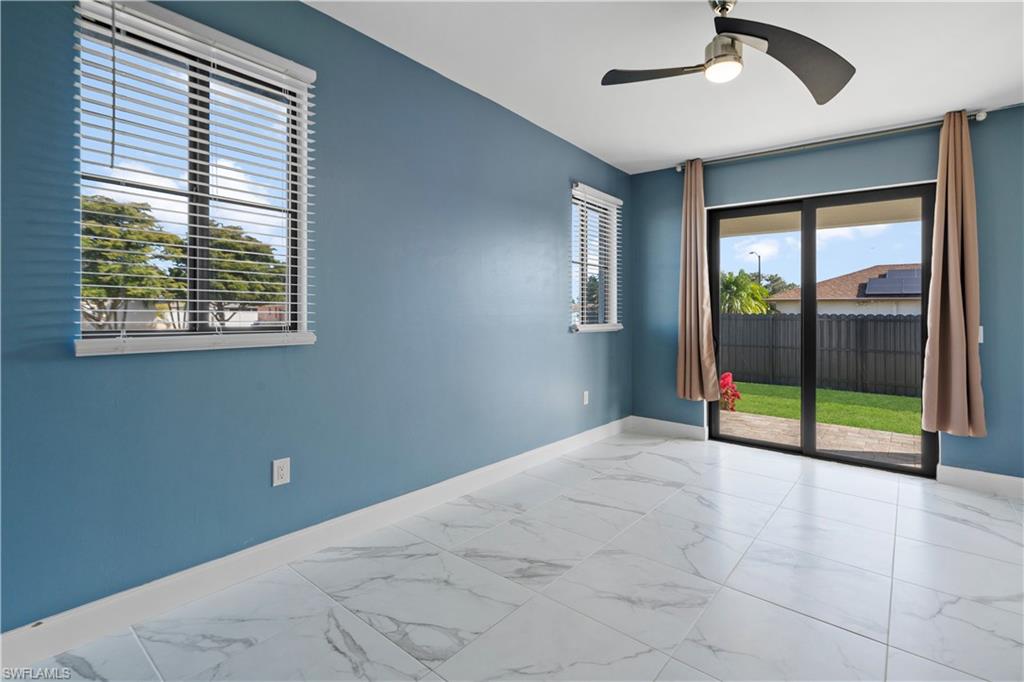 Interior room featuring white marble-look tile flooring and blue wall finishes