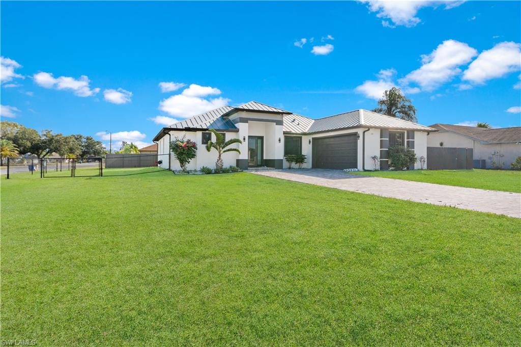 Contemporary single-story residence with a white stucco exterior and dark trim accents