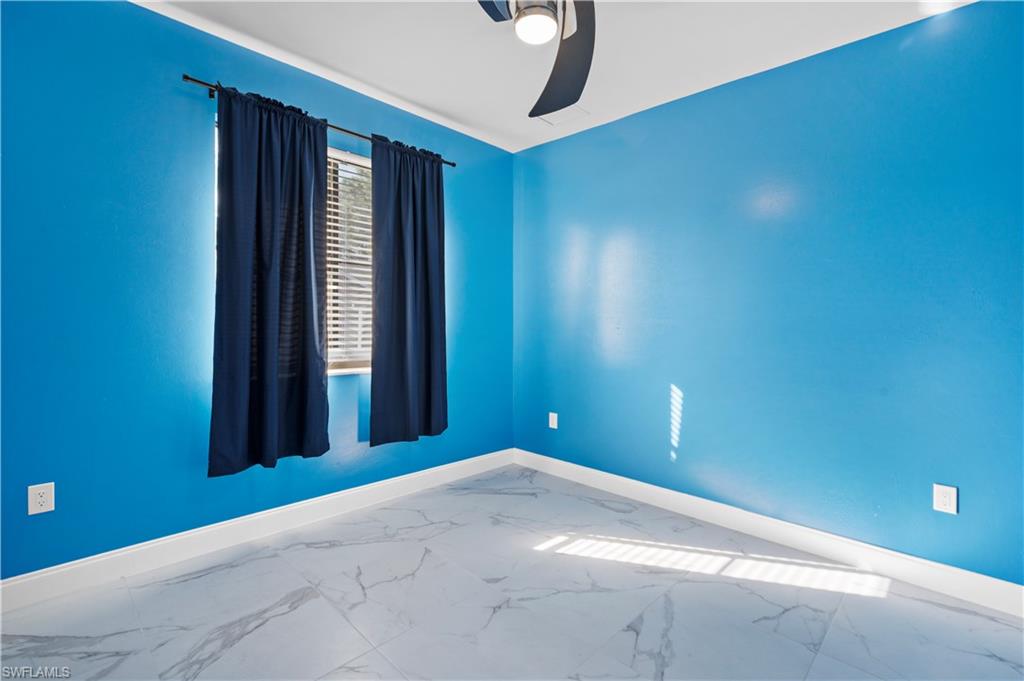 Room featuring light blue walls, white baseboards, and wood-finish flooring