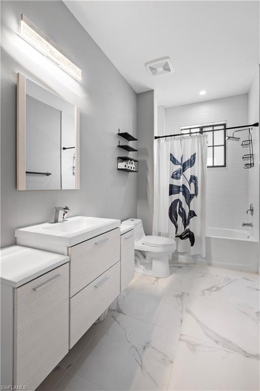 Modern bathroom featuring wood-finish vanity with integrated sink, white marble-look tile flooring, and a shower-over-tub combination with white subway tile surround