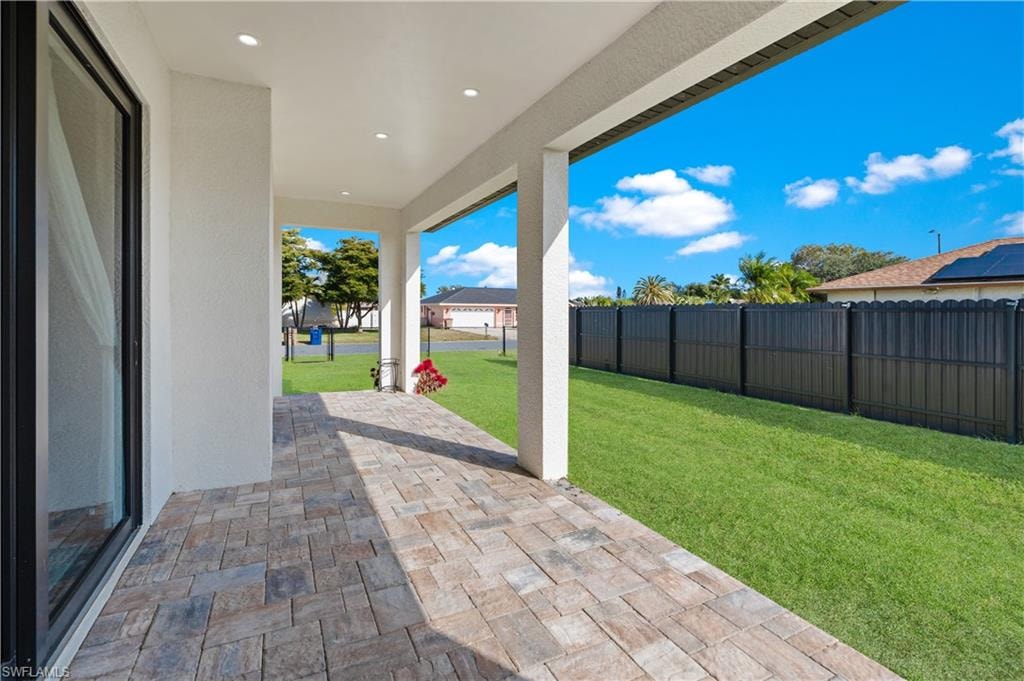 Covered patio featuring an expansive paver stone surface