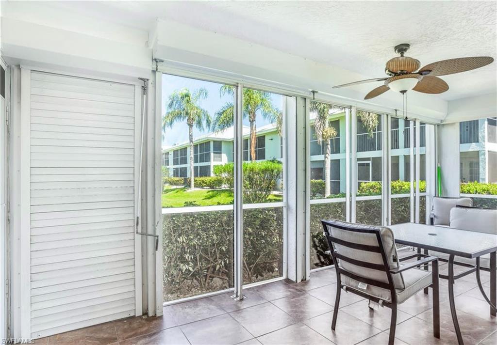 Screened lanai featuring tiled flooring and a ceiling fan