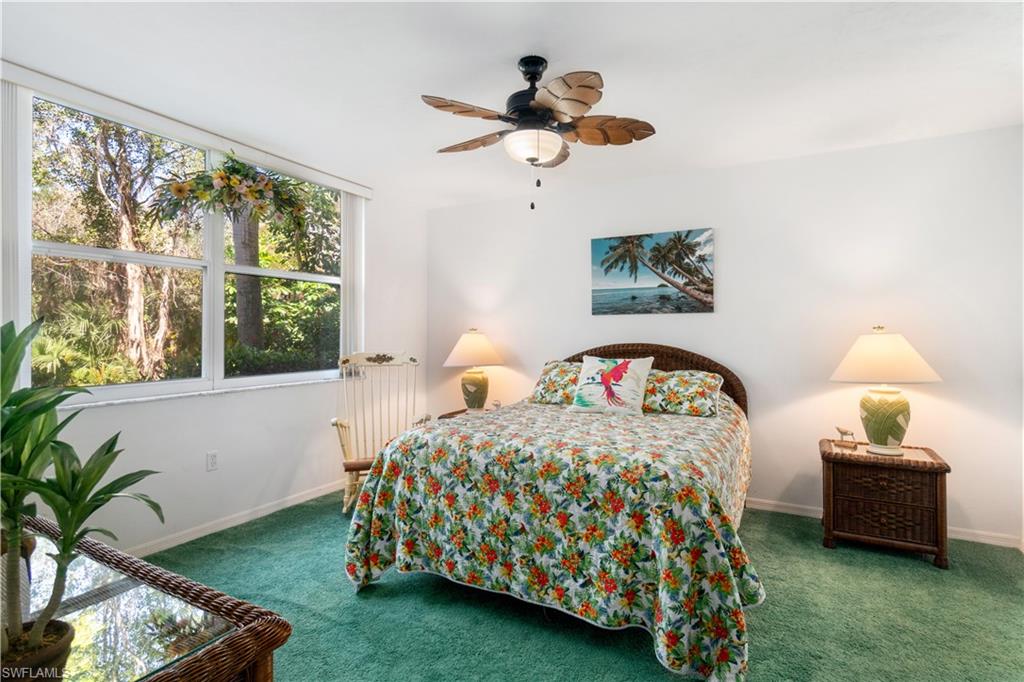 Primary Bedroom with a large double window looking out onto the woods