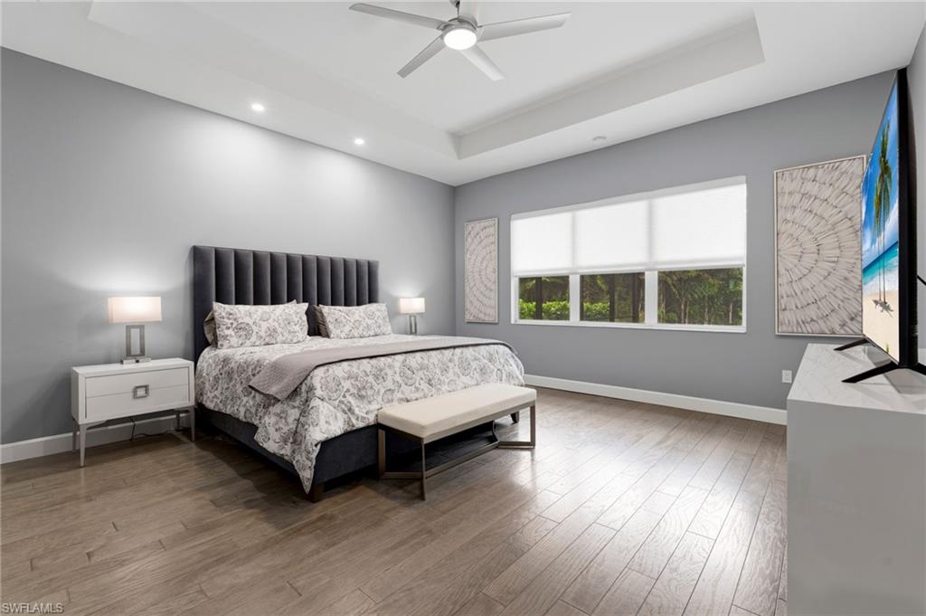 Inviting primary suite with sitting area, electric window treatments.