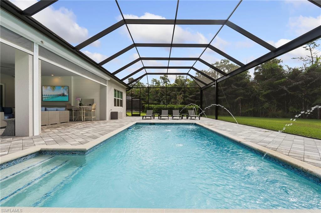 Large pool with water features for optimal relaxation or pool fun.