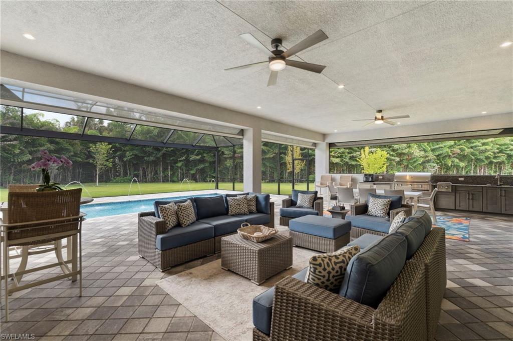 Experience optimal outdoor living with a 37' x 22' covered lanai area, with premium built-in outdoor kitchen, and feature wall, all protected from rain or storms with electric storm screens.