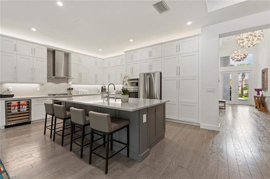 Experience luxury from the moment you step into the grand foyer to the massive great room, kitchen, and dining area, all boasting luxurious hardwood flooring throughout.