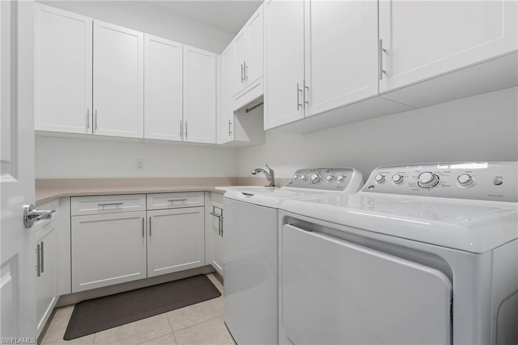 Spacious Laundry room with built-in cabinets and laundry sink.