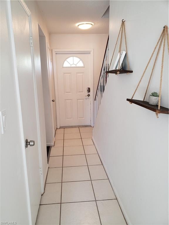 From living room to front entry with half bath on the left side door