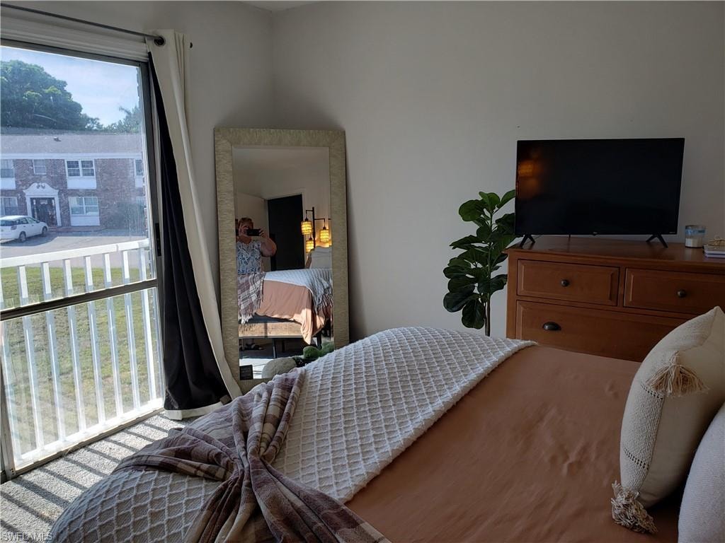 Bedroom 2 with nice light and view out to pool area and open grassy area.