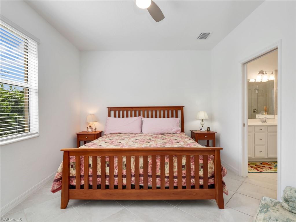 Bright room with neutral wall paint, tile flooring, and a ceiling fan