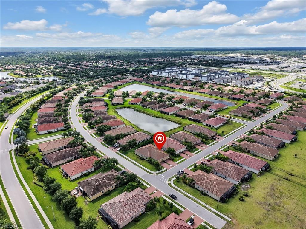 Residential community featuring curvilinear streets and individual properties with green lawns