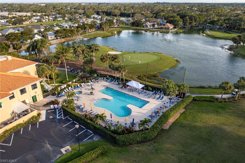 Drone / aerial view featuring golf course view and a water view