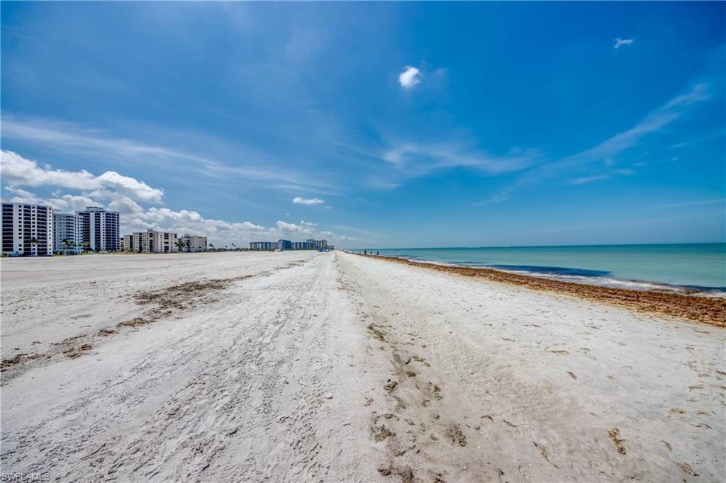 Expansive beachfront with white sand and clear blue water