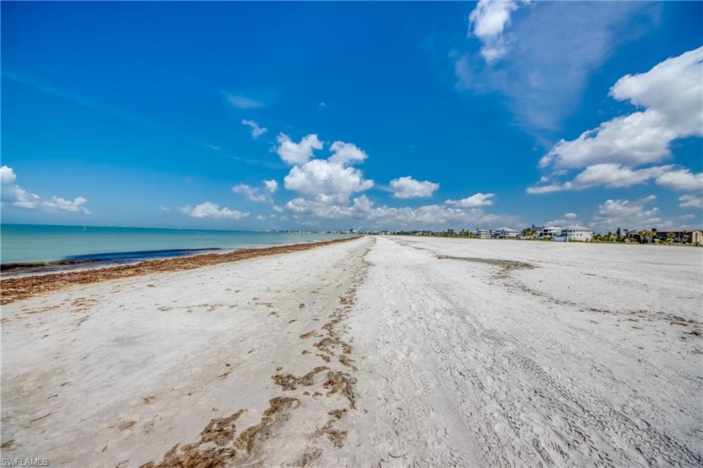 Expansive sandy beach with clear blue waters