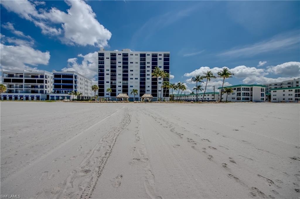Expansive sandy beach frontage with multiple condominium buildings