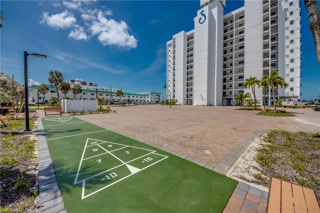 Shuffleboard court featuring a green surface with white markings