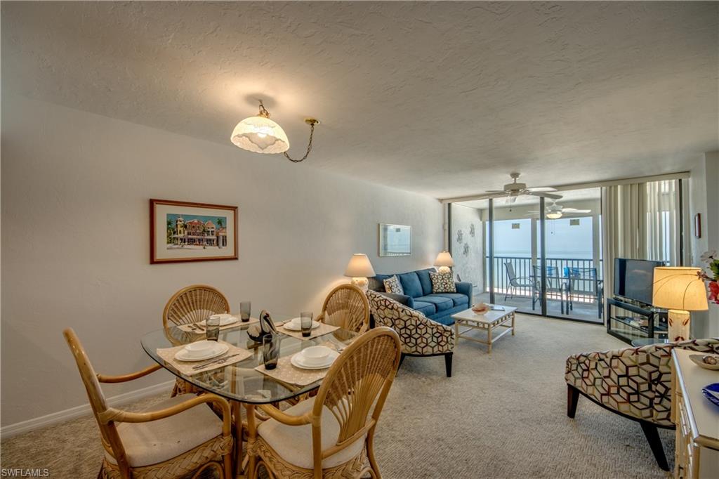 Open concept living area with broad sliding glass doors leading to an outdoor balcony