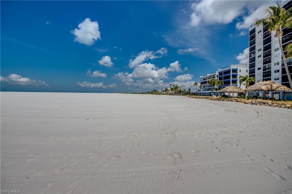 Expansive sandy beach with waterfront high-rise buildings