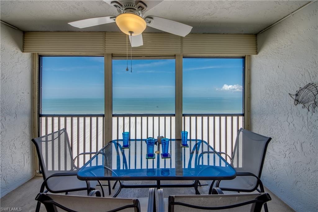 Expansive water scenery framed by large windows and balcony railing