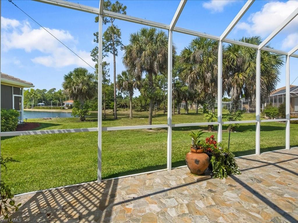 Screened outdoor living space featuring natural stone tile flooring