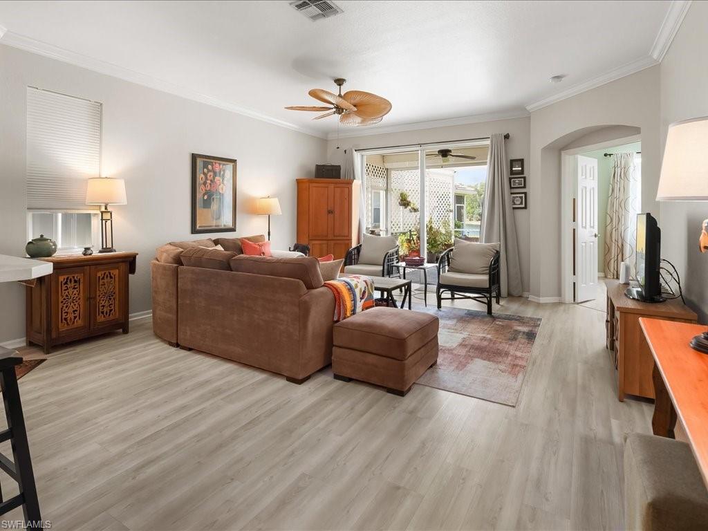Spacious interior featuring light wood-finish flooring and crown molding