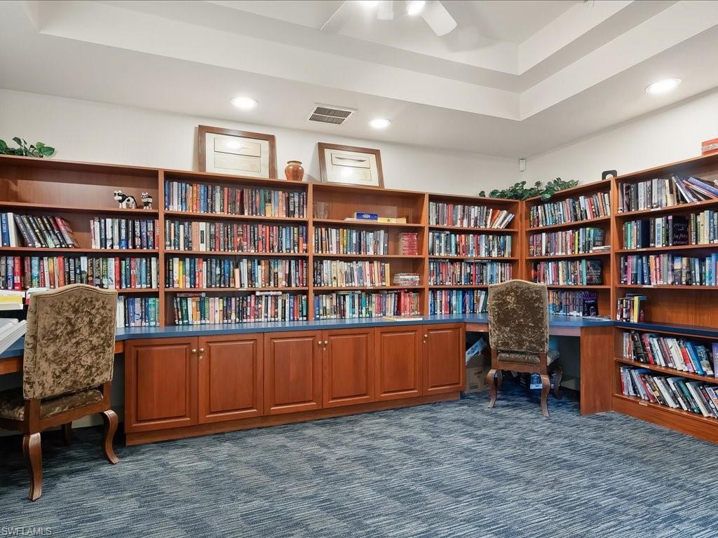 Comprehensive library with extensive built-in shelving, integrated desks, and lower cabinetry