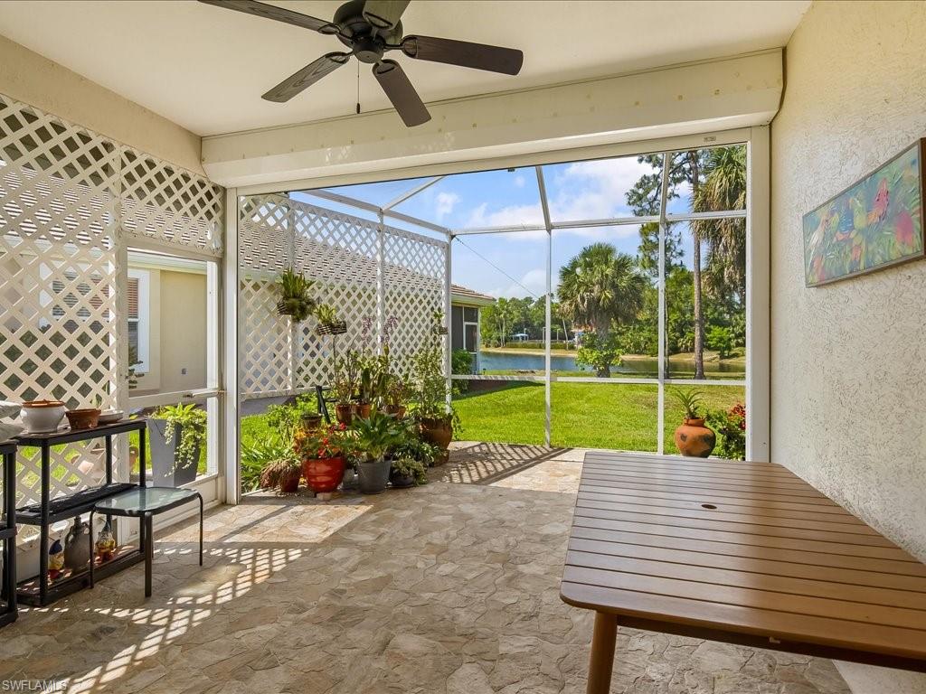 Screened patio with stone-finish flooring and a ceiling fan