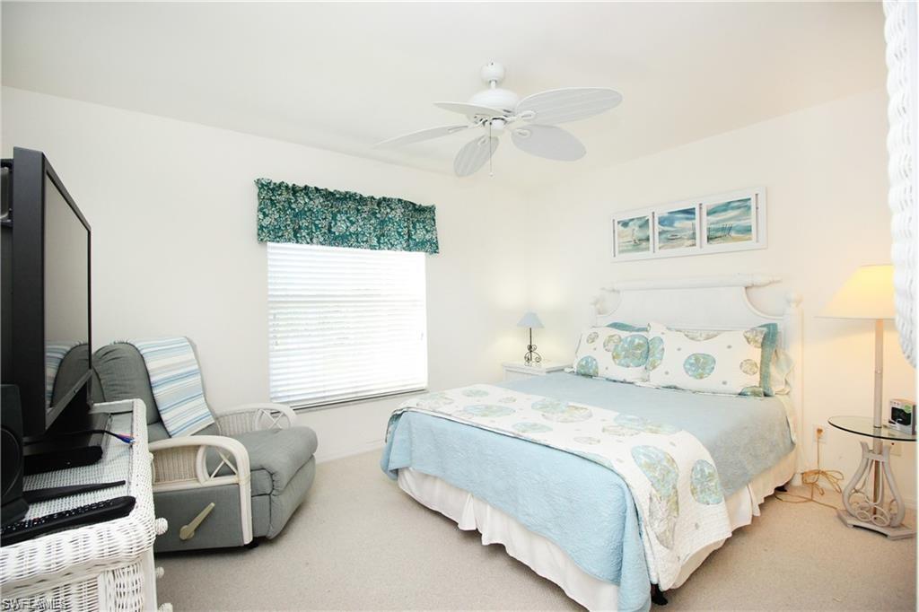 Bedroom with ceiling fan and carpet
