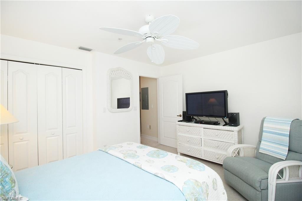Bedroom featuring electric panel, ceiling fan, and a closet