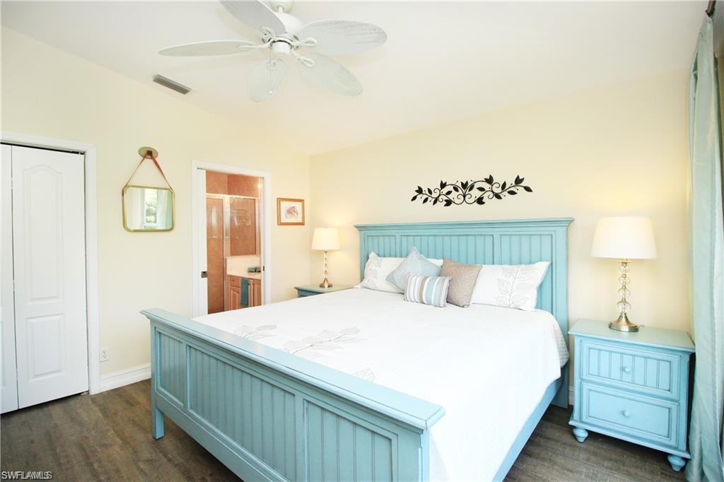 Bedroom featuring ceiling fan, dark hardwood / wood-style floors, a closet, and ensuite bathroom