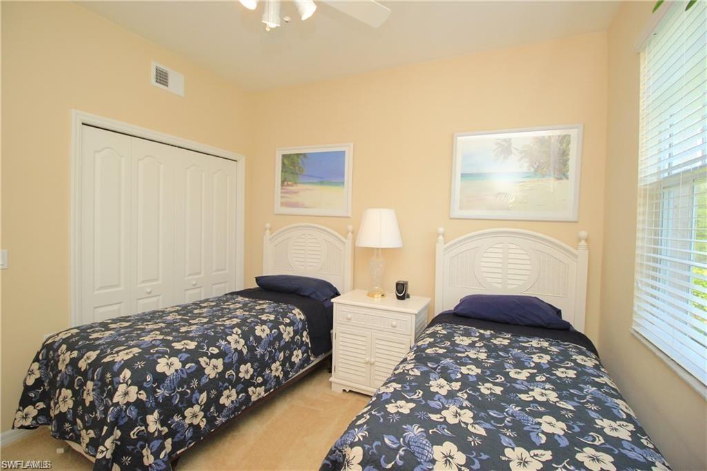 Bedroom featuring a closet, ceiling fan, and light colored carpet