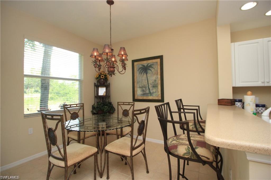 Dining room featuring light tile patterned floors and an inviting chandelier
