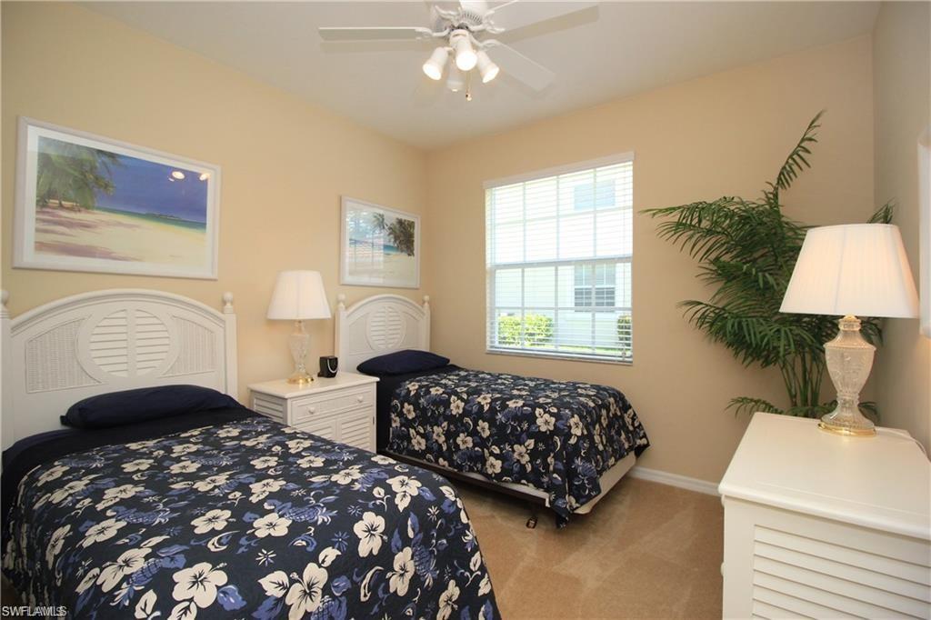 Carpeted bedroom with ceiling fan