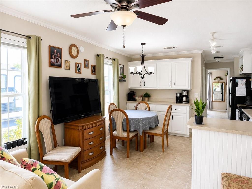 Open-concept living area with tile flooring and a ceiling fan