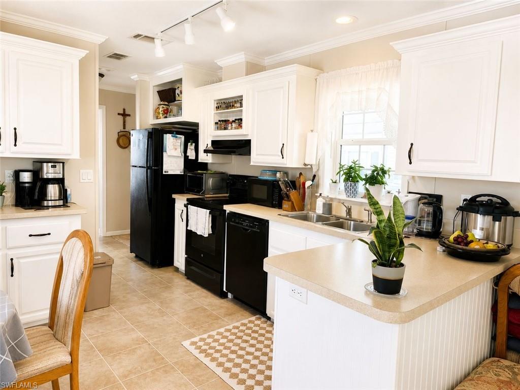Bright kitchen featuring white cabinetry and light countertops