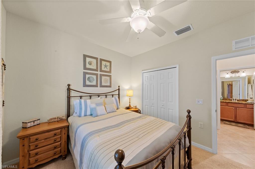 Carpeted bedroom featuring a ceiling fan, bi-fold closet doors, and recessed lighting