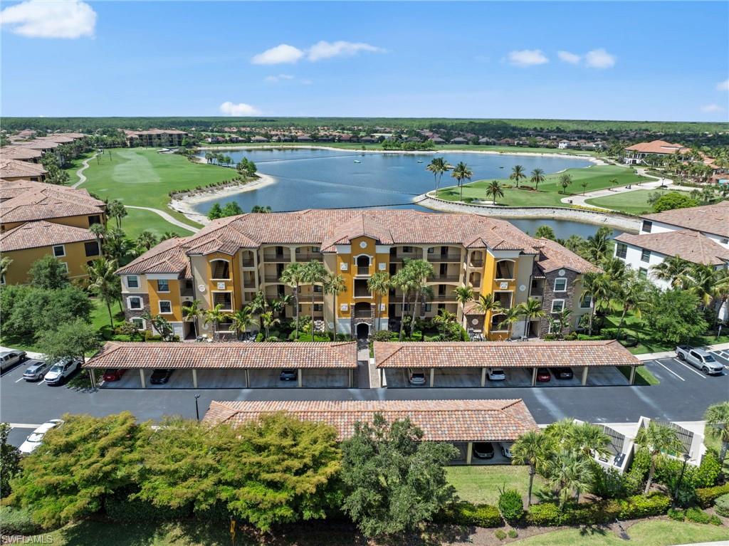 Mediterranean-style multi-story building featuring terracotta roof tiles, multiple balconies, and integrated carports