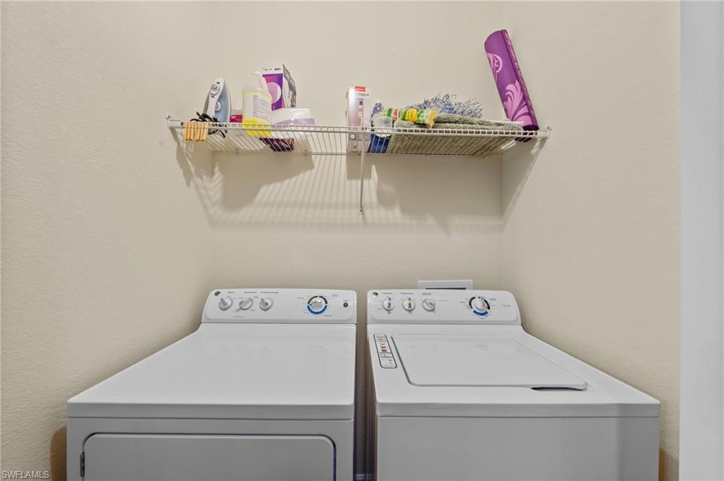 Dedicated laundry area featuring a wire shelving unit
