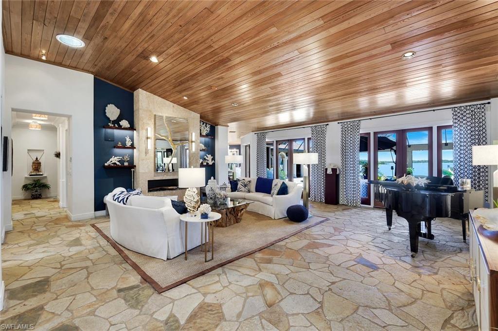 Spacious living area featuring irregular flagstone flooring and a polished wood-finish ceiling