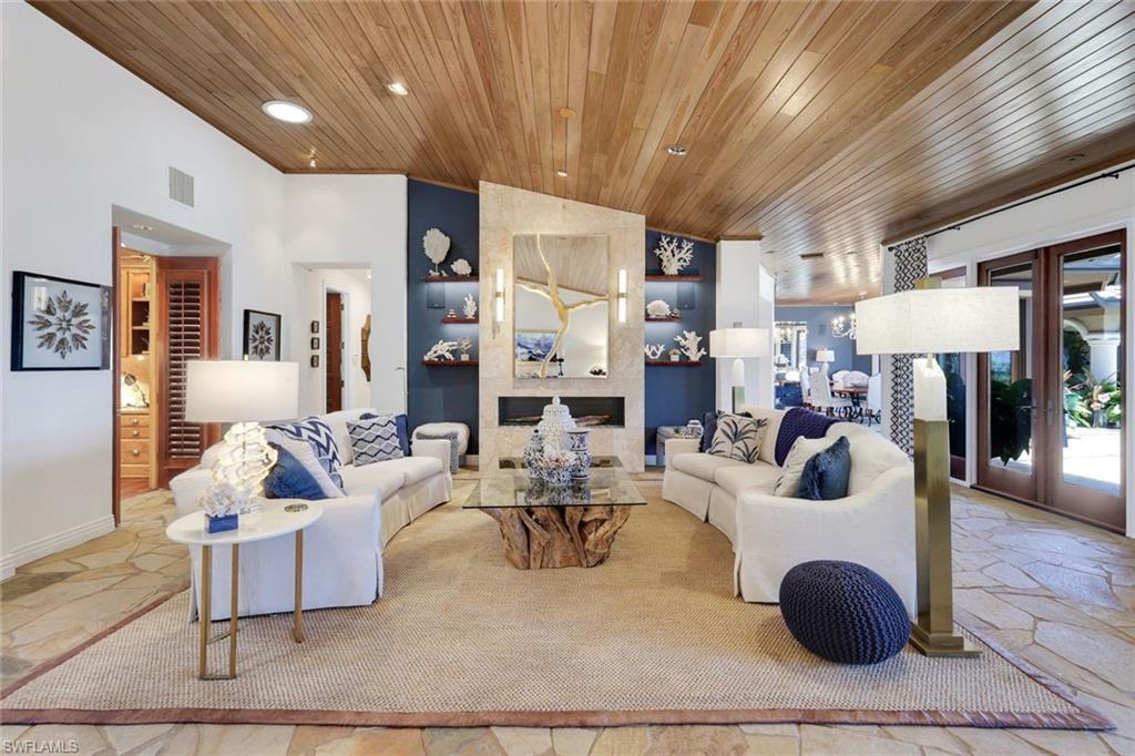 Living area featuring a natural wood plank ceiling and flagstone flooring