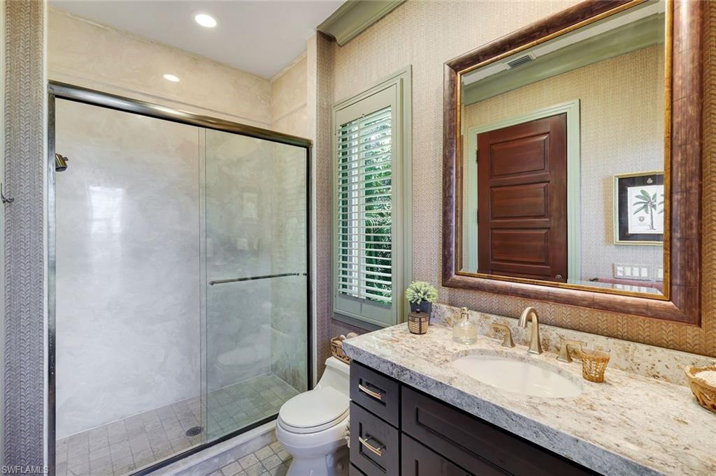 Bathroom vanity featuring a light-colored countertop with an integrated sink and a bronze-toned faucet