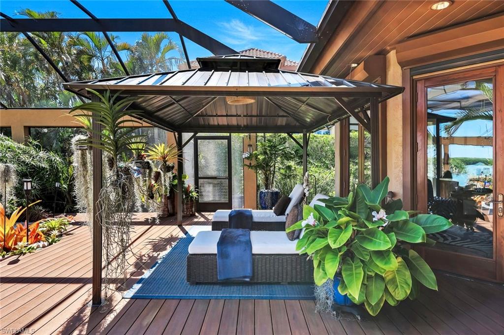 Screened outdoor living area featuring a covered gazebo