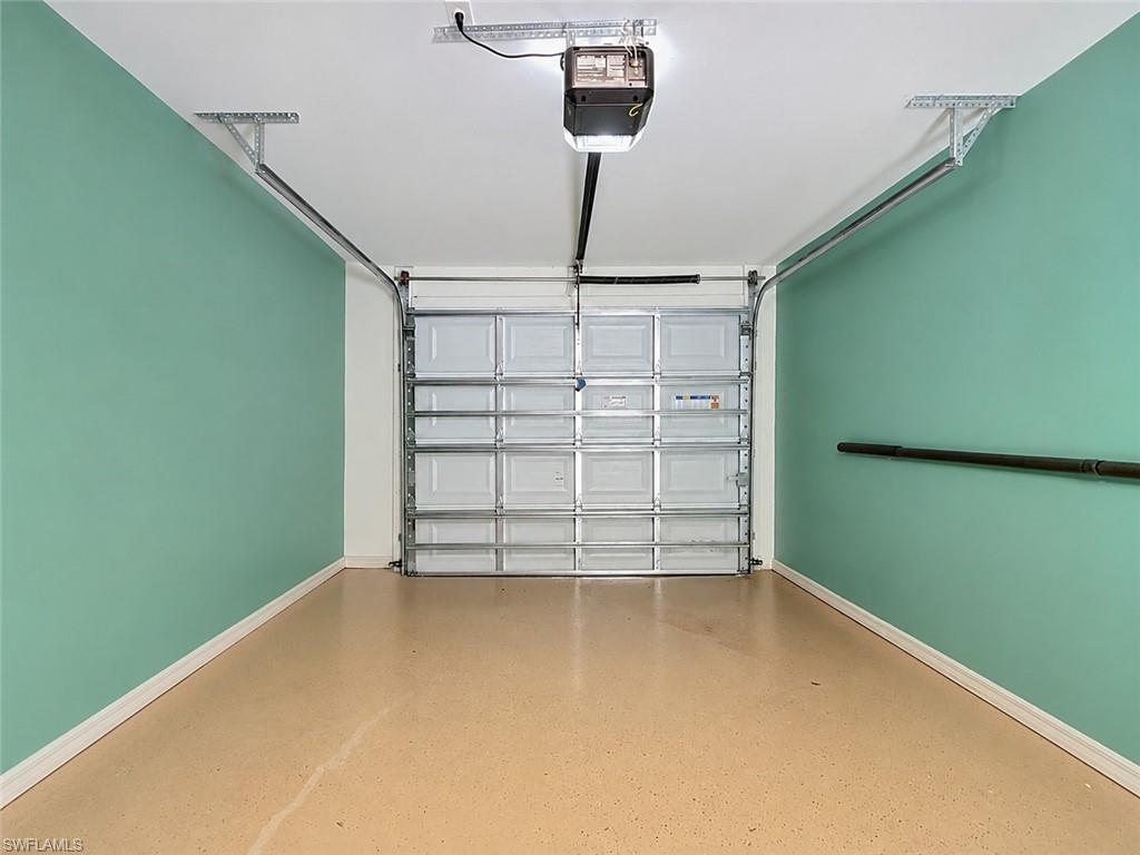 Extra Deep Single-car garage featuring a speckled epoxy floor