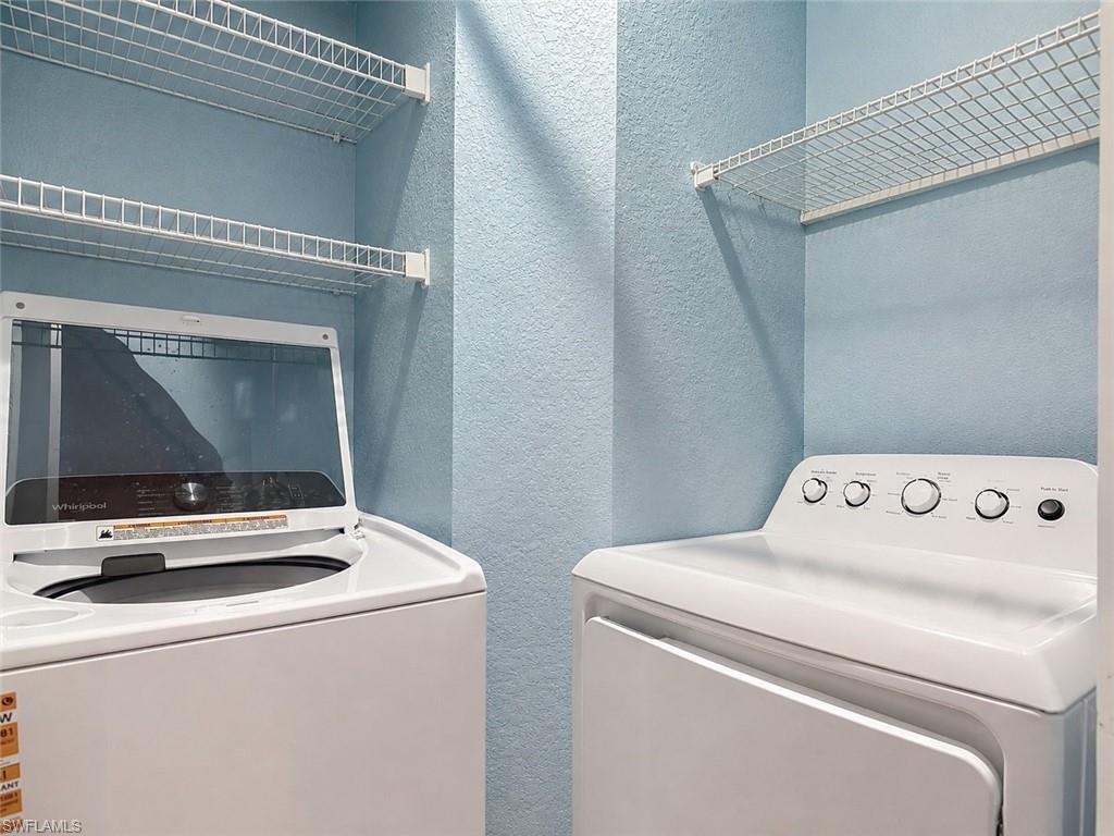 Dedicated laundry area featuring a top-load washing machine and a front-load dryer